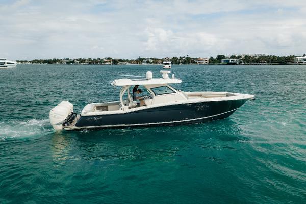 Scout 380 LXF 2021 Scout 380 LXF boat cruising on clear blue water.