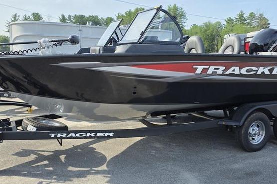 Tracker Targa v18 combo 2026 Tracker Targa V18 Combo boat on trailer, black with red accents, parked outdoors.