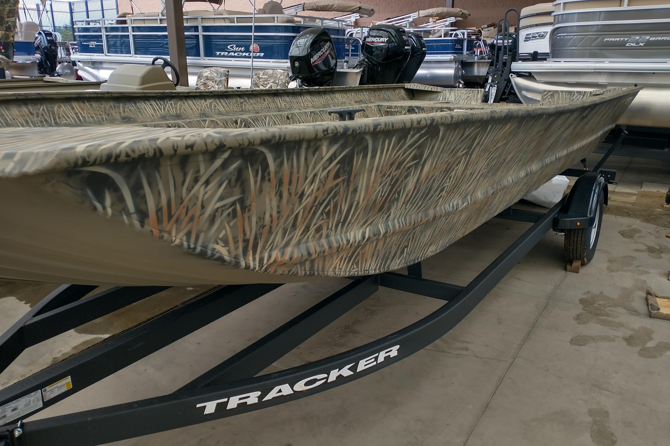 Tracker GRIZZLY 2072 Utility 2026 Tracker GRIZZLY 2072 Utility boat with camouflage design on a trailer.