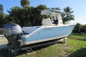 Cobia 280 Center Console 2020 Cobia 280 Center Console boat with Yamaha engine, parked on grass.