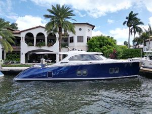 Zeelander 5 2023 Zeelander 5 yacht docked by a luxurious waterfront villa with palm trees.