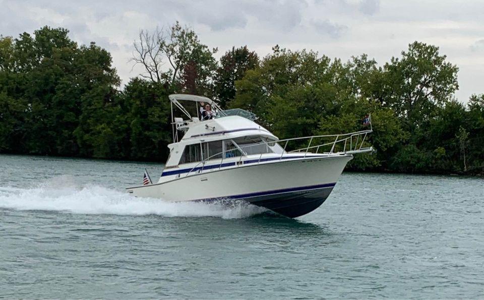 Bertram 33 Flybridge Cruiser 1983 Bertram 33 Flybridge Cruiser on water, surrounded by trees.