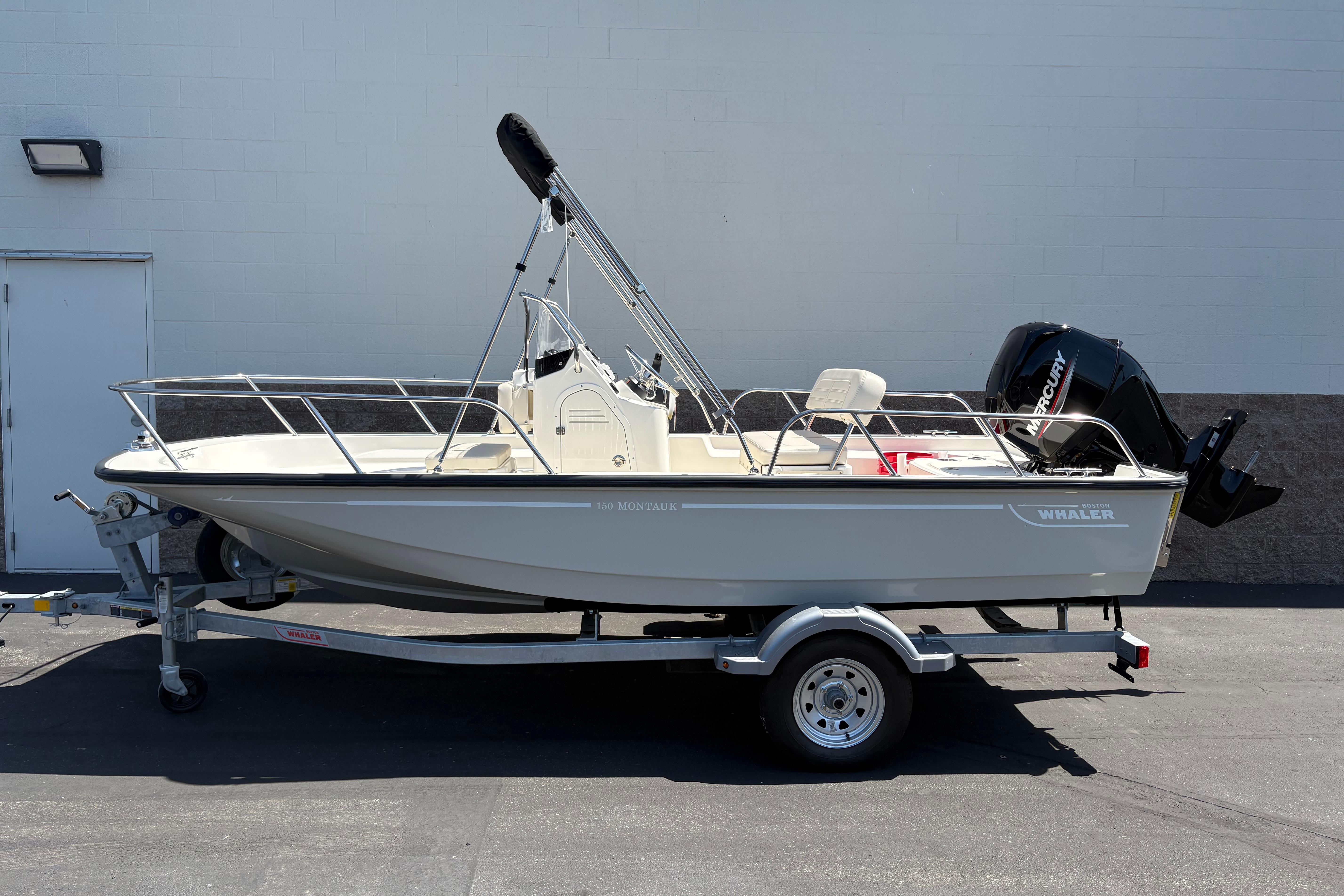 Boston Whaler 150 Montauk 2026 Boston Whaler 150 Montauk boat on trailer, side view, outdoors.