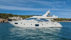 Azimut 75 2008 Azimut 75 yacht cruising on serene blue waters near a coastal town.