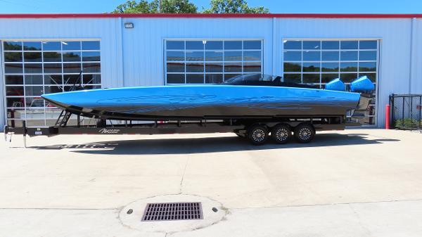Skater 388 2025 Skater 388 speedboat on a trailer outside a garage.