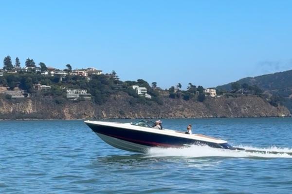 Chris-Craft Launch 25 2008 Chris-Craft Launch 25 speedboat cruising on scenic coastal waters.