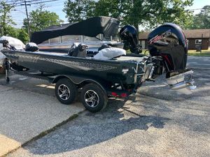 Ranger RT198P 2025 Ranger RT198P boat on trailer, featuring powerful outboard motor, parked outdoors.