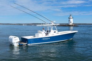 Regulator 34SS 2018 Regulator 34SS boat on water near lighthouse, clear sky.