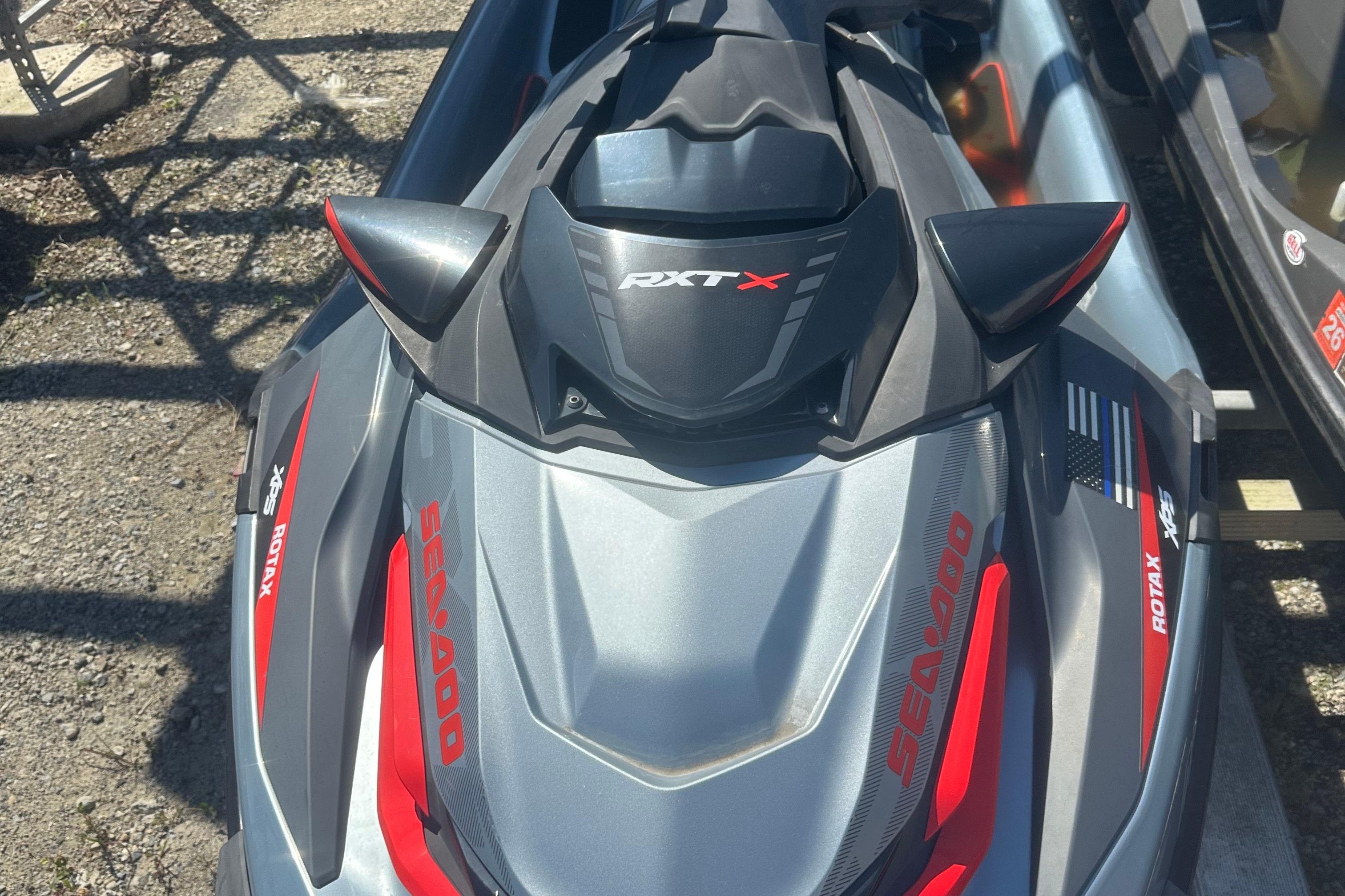 Sea-Doo RXT-X 300 2018 Sea-Doo RXT-X 300 jet ski, gray and red design, parked outdoors.