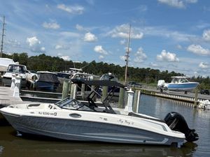 Bayliner VR6 2019 Bayliner VR6 boat docked at marina under blue sky.
