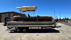 Sun Tracker Party Barge 22 XP3 2025 Sun Tracker Party Barge 22 XP3 pontoon boat on trailer, parked outdoors.