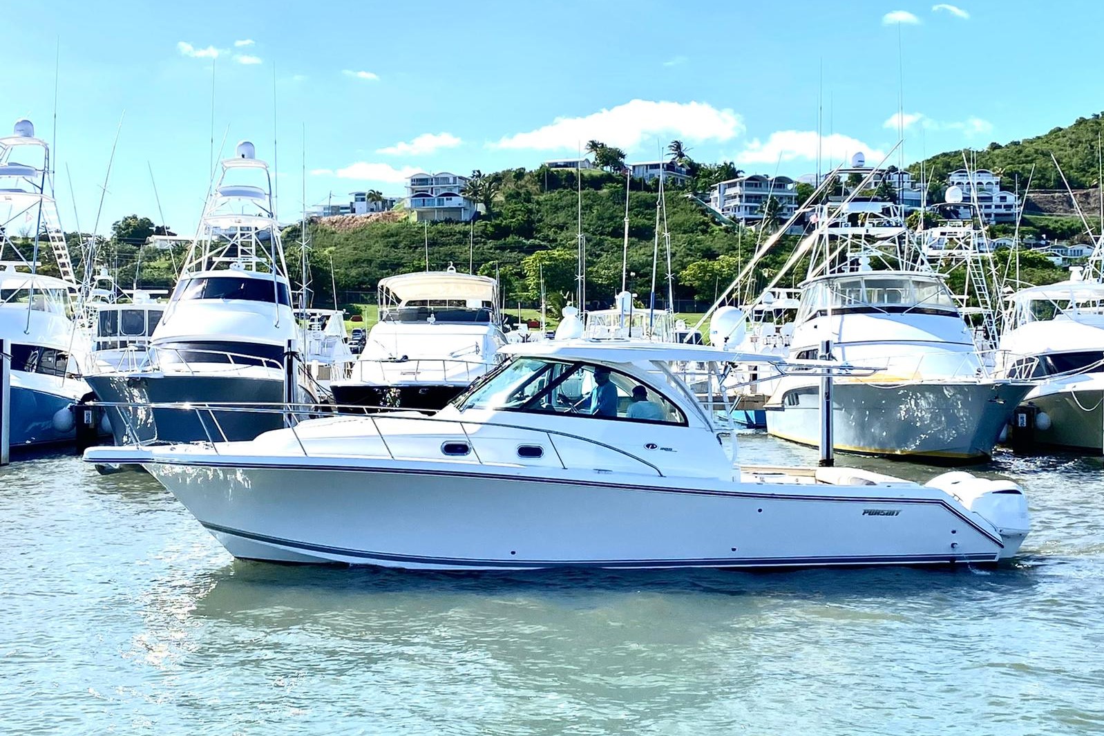 Pursuit OS 385 Offshore 2018 Pursuit OS 385 Offshore boat docked in a marina, surrounded by other yachts.