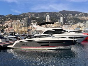 Windy 37 Shamal 2023 Windy 37 Shamal yacht docked in a scenic marina with mountainous backdrop.