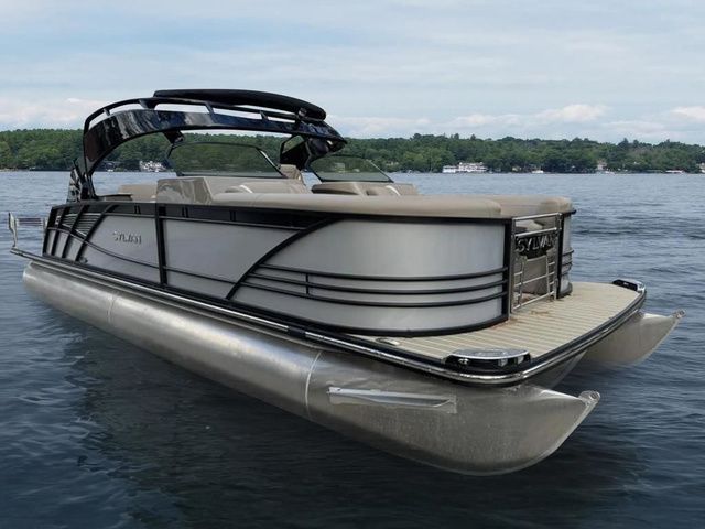 Sylvan S3 DLZ DC 2024 Sylvan S3 DLZ DC pontoon boat on a calm lake.