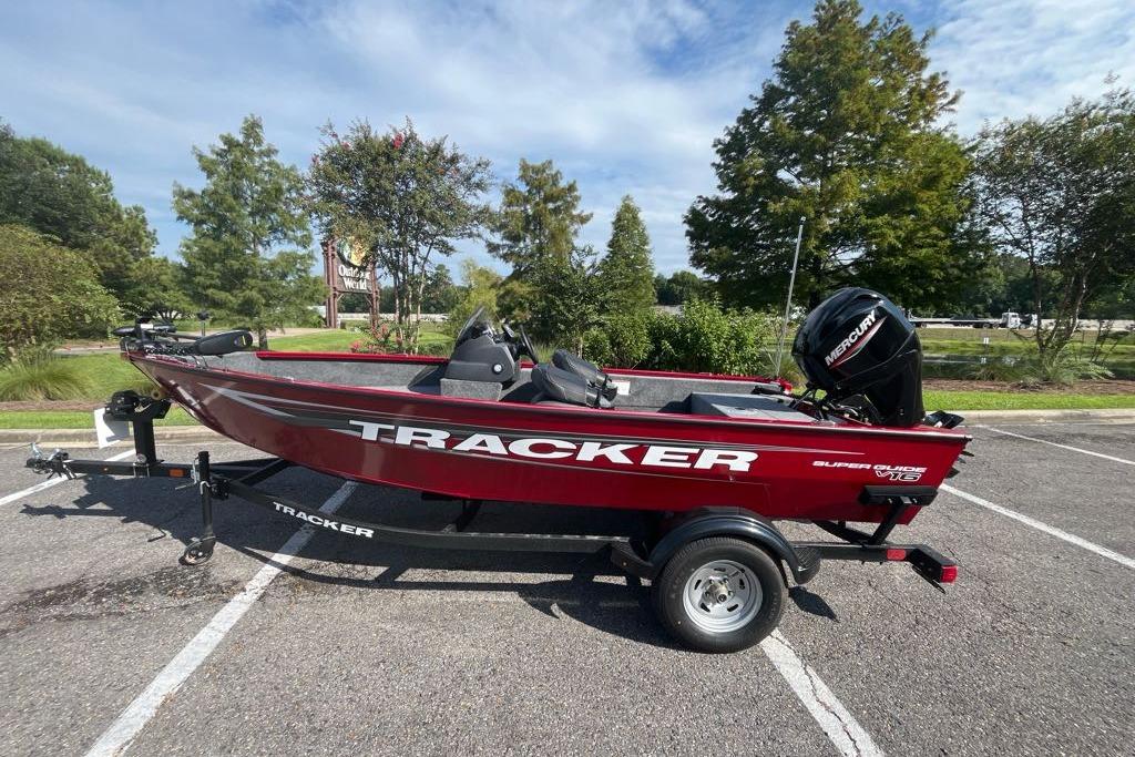Tracker Super Guide V-16 SC 2026 Tracker Super Guide V-16 SC boat on trailer in parking lot.