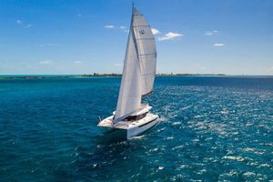 Leopard 50 2024 Leopard 50 catamaran sailing on clear blue ocean under sunny skies.