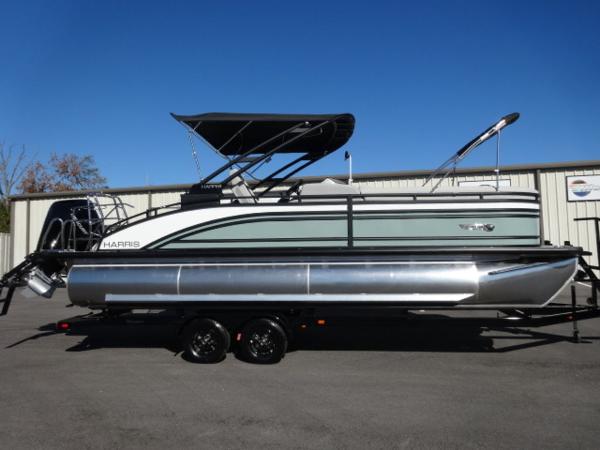 Harris Solstice 250 2025 Harris Solstice 250 pontoon boat with canopy on trailer, parked outdoors.