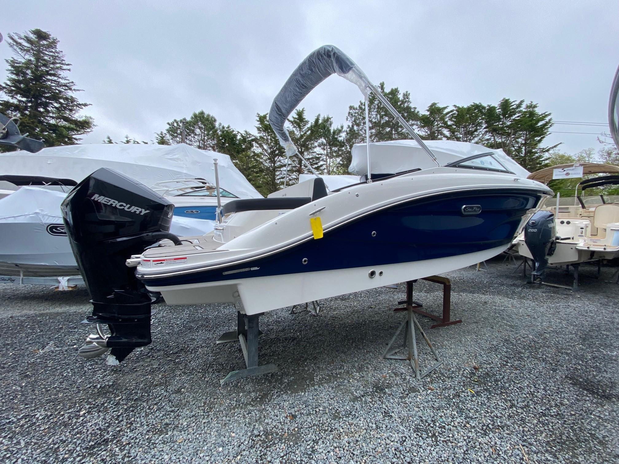 Sea Ray SPX 210 Outboard 2025 Sea Ray 210 SPX Outboard boat with Mercury engine on display.