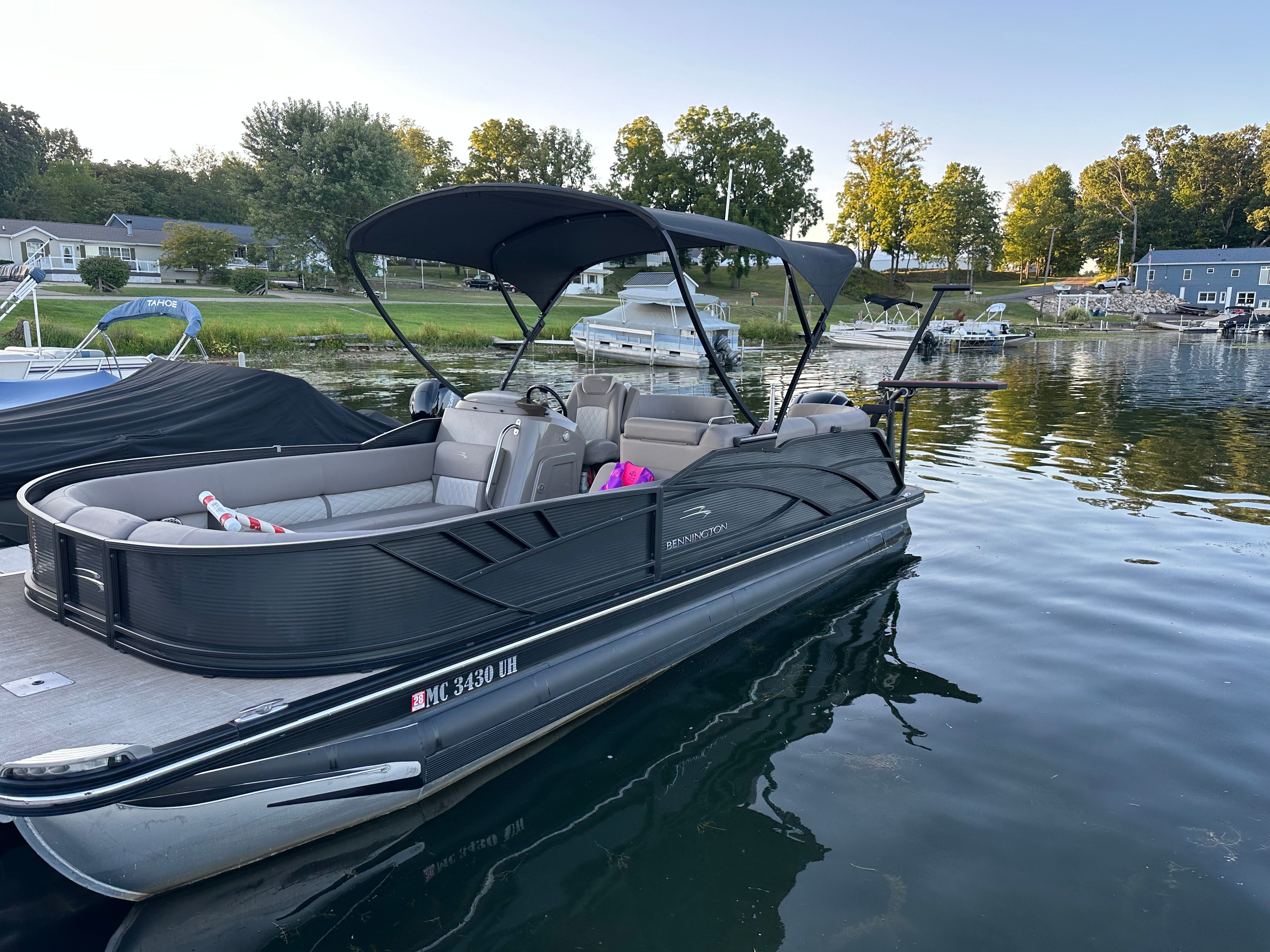 Bennington 22’ bowrider Custom 2020 Bennington 22’ bowrider Custom boat docked on a calm lake.