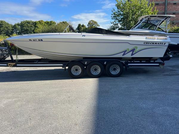 Checkmate 253 Convincor 1994 Checkmate 253 Convincor boat on trailer, parked outdoors.