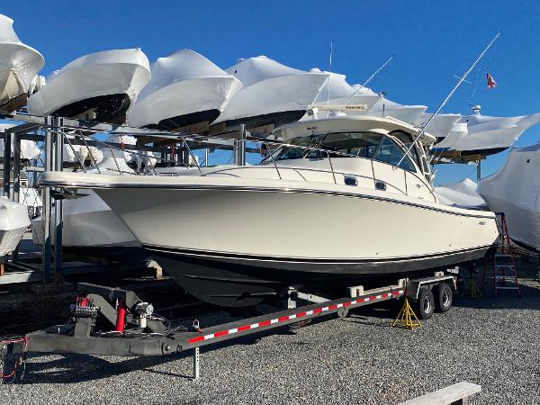 Pursuit OS 375 Offshore 2009 Pursuit OS 375 Offshore boat on trailer, surrounded by other boats in storage.