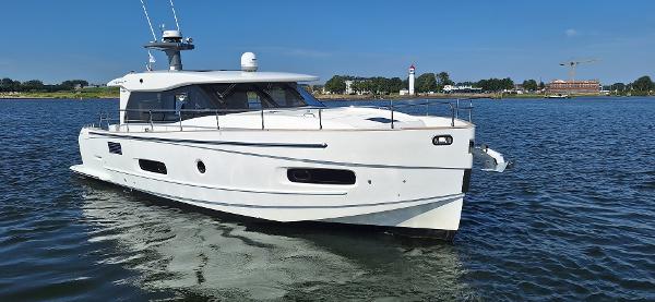 Azimut Magellano 43 Azimut Magellano 43 yacht, 2021 model, cruising on calm waters under a clear blue sky.
