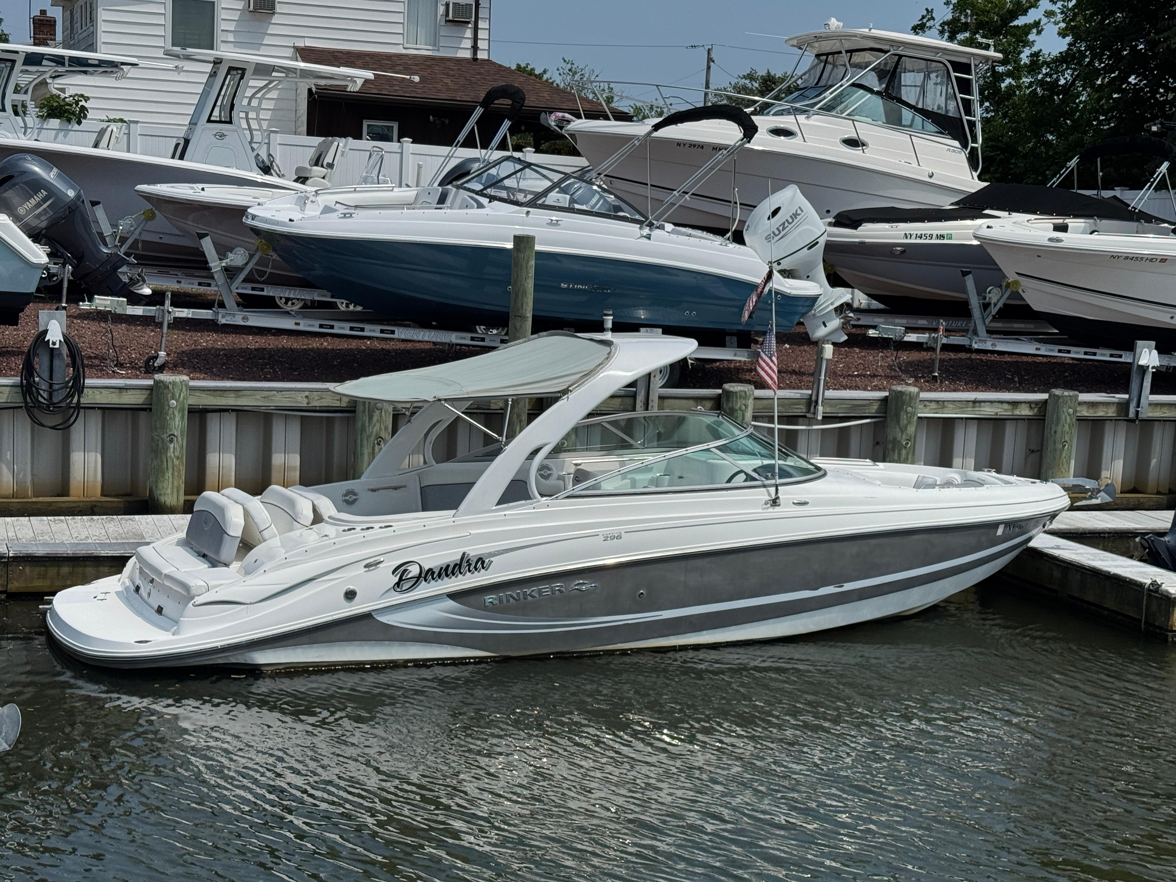 Rinker 296 Captiva Bowrider 2013 Rinker 296 Captiva Bowrider docked at marina, surrounded by other boats.