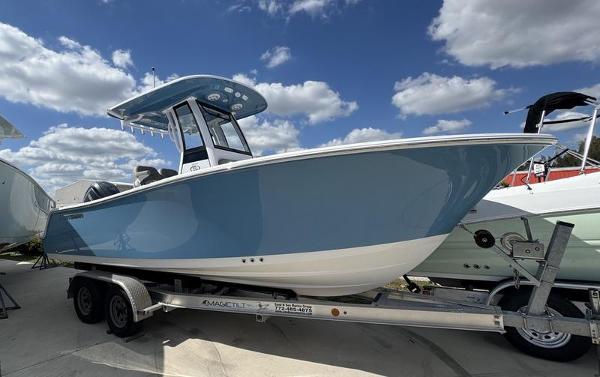 Sportsman Open 212 2025 Sportsman Open 212 boat on trailer under blue sky with clouds.