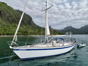 Hallberg-Rassy 45 1990 Hallberg-Rassy 45 sailboat anchored in scenic tropical bay with lush mountains.