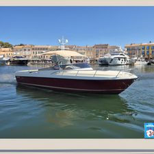 Asterie ASTERIE 40 DAY CRUISER Asterie 40 Day Cruiser 2013 in a scenic marina with yachts and buildings.