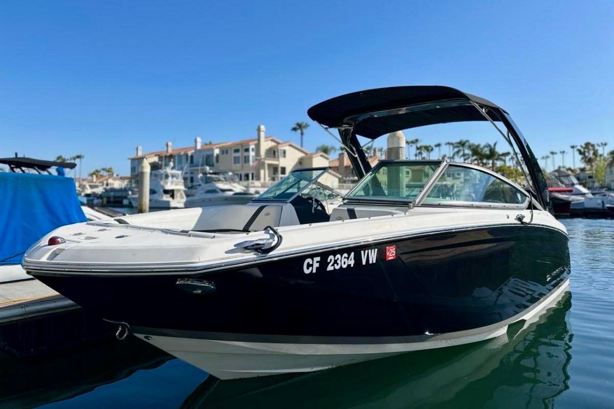 Regal 23 OBX 2016 Regal 23 OBX boat docked in a sunny marina setting.