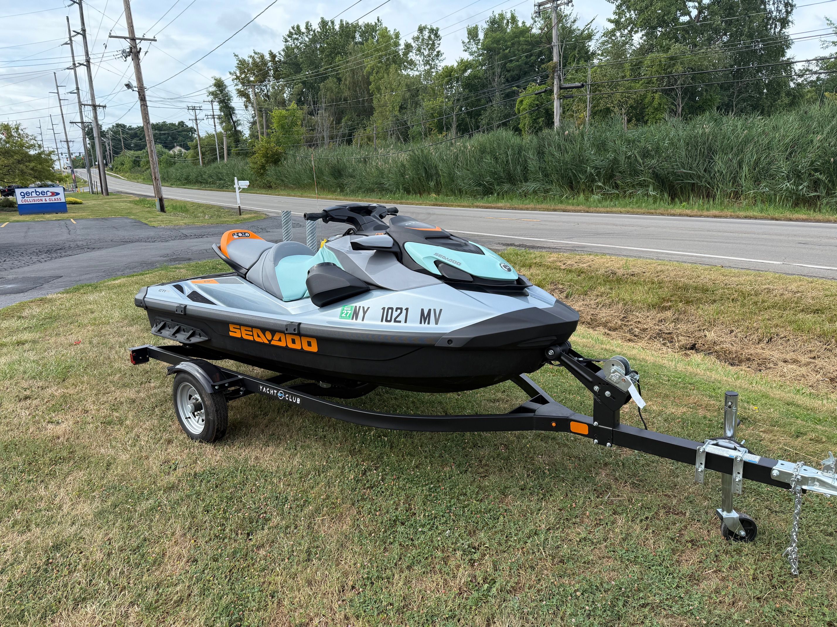 Sea-Doo GTI SE 170 Tech, Audio, iDF, iBR 2024 Sea-Doo GTI SE 170 on trailer, parked on grass near road.