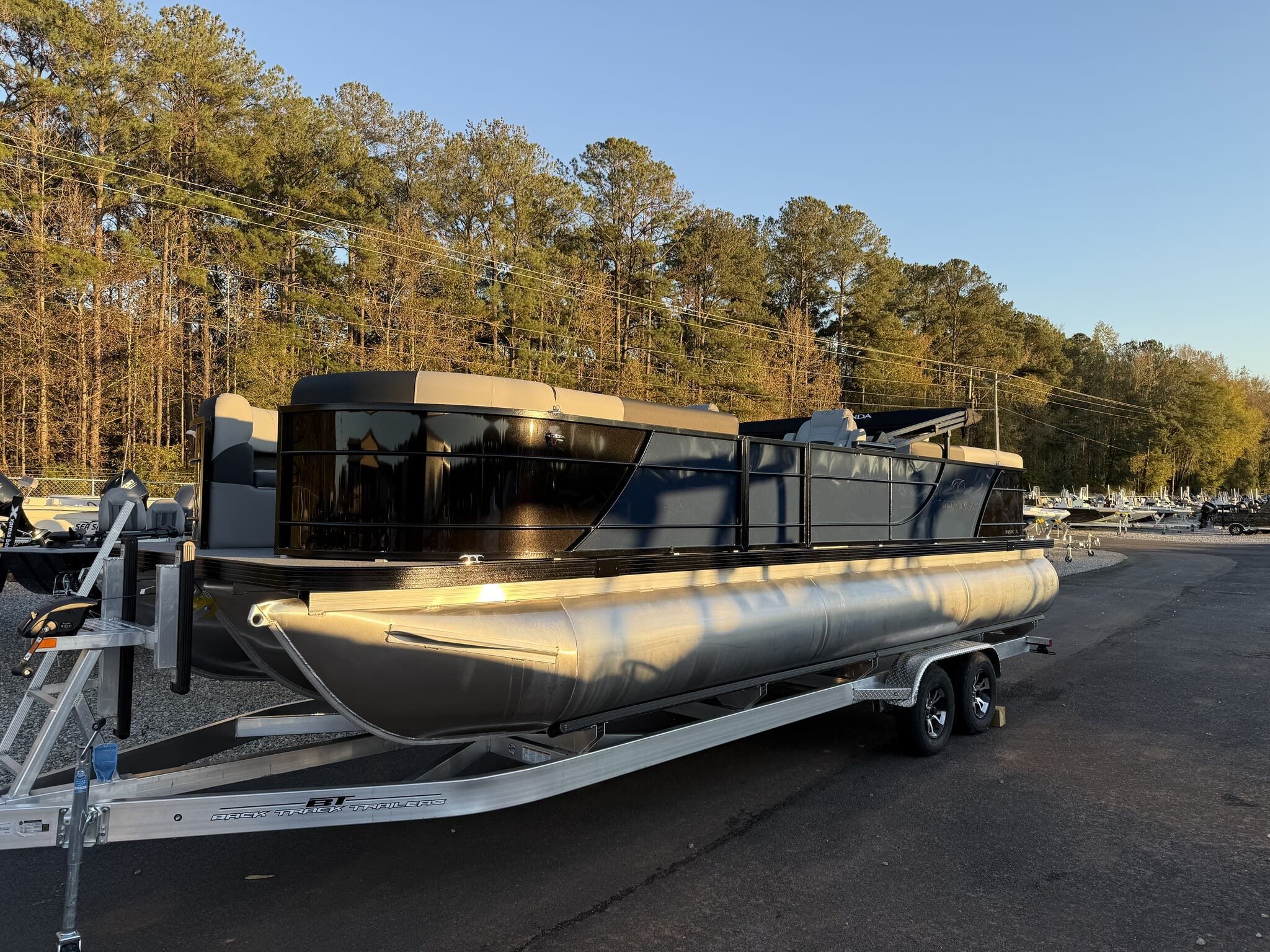 Veranda Relax Series VR25RC XL 2025 Veranda Relax Series VR25RC XL pontoon boat on trailer, parked outdoors.