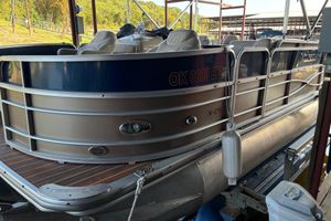 Xcursion X-21F 2013 Xcursion X-21F pontoon boat docked, featuring sleek design and comfortable seating.