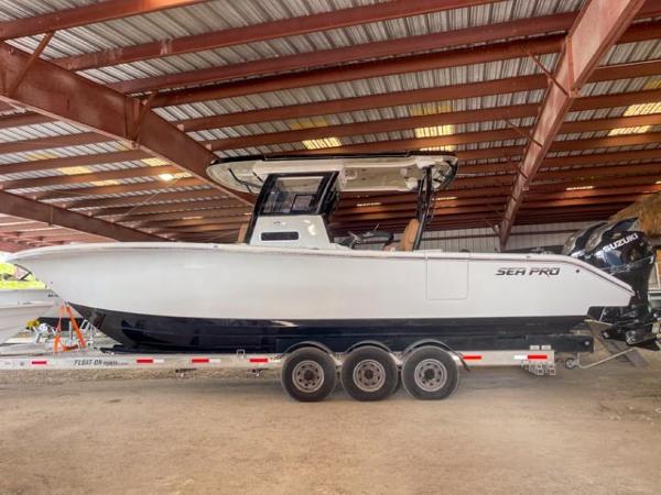 Sea Pro 322 Offshore 2025 Sea Pro 322 Offshore boat on a trailer in a covered storage area.