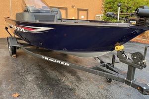 Tracker Pro Guide V-16 SC 2026 Tracker Pro Guide V-16 SC boat on trailer, parked outdoors.