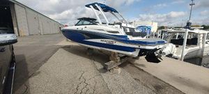 Monterey M4 2021 Monterey M4 boat on blocks at a marina, blue and white design.