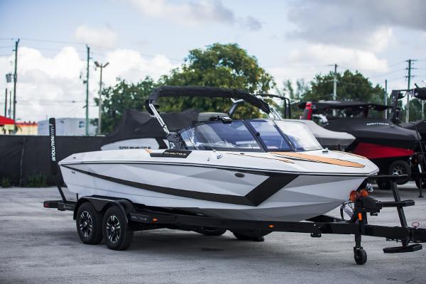 Nautique Ski 2025 Nautique Ski boat on trailer, sleek design, parked outdoors.