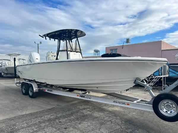 Pathfinder 2700 Open 2025 Pathfinder 2700 Open boat on trailer, parked outdoors under cloudy sky.