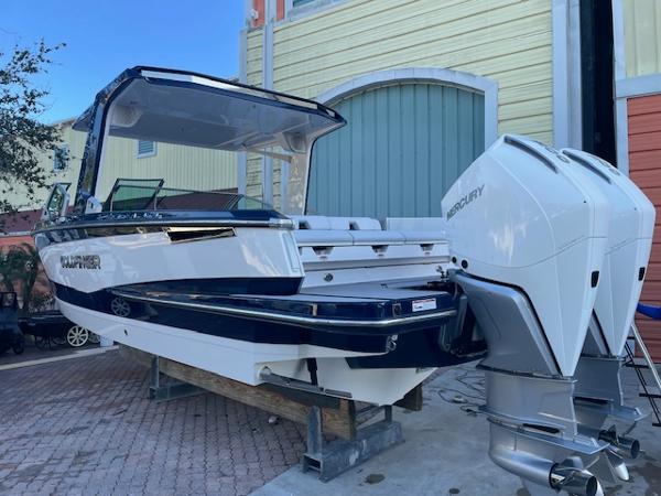 Aviara AV 32-OB 2022 Aviara AV 32-OB boat with dual Mercury outboard engines, docked outdoors.