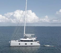 Sunreef 60 Sailing 2022 Sunreef 60 Sailing yacht on calm ocean waters under a cloudy sky.