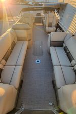 Sun Tracker Party Barge 22 XP3 2025 Sun Tracker Party Barge 22 XP3 interior with beige seating and sunlit deck.