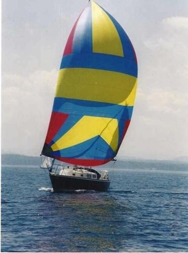 Tartan 30 1974 Tartan 30 sailboat with colorful spinnaker on open water.