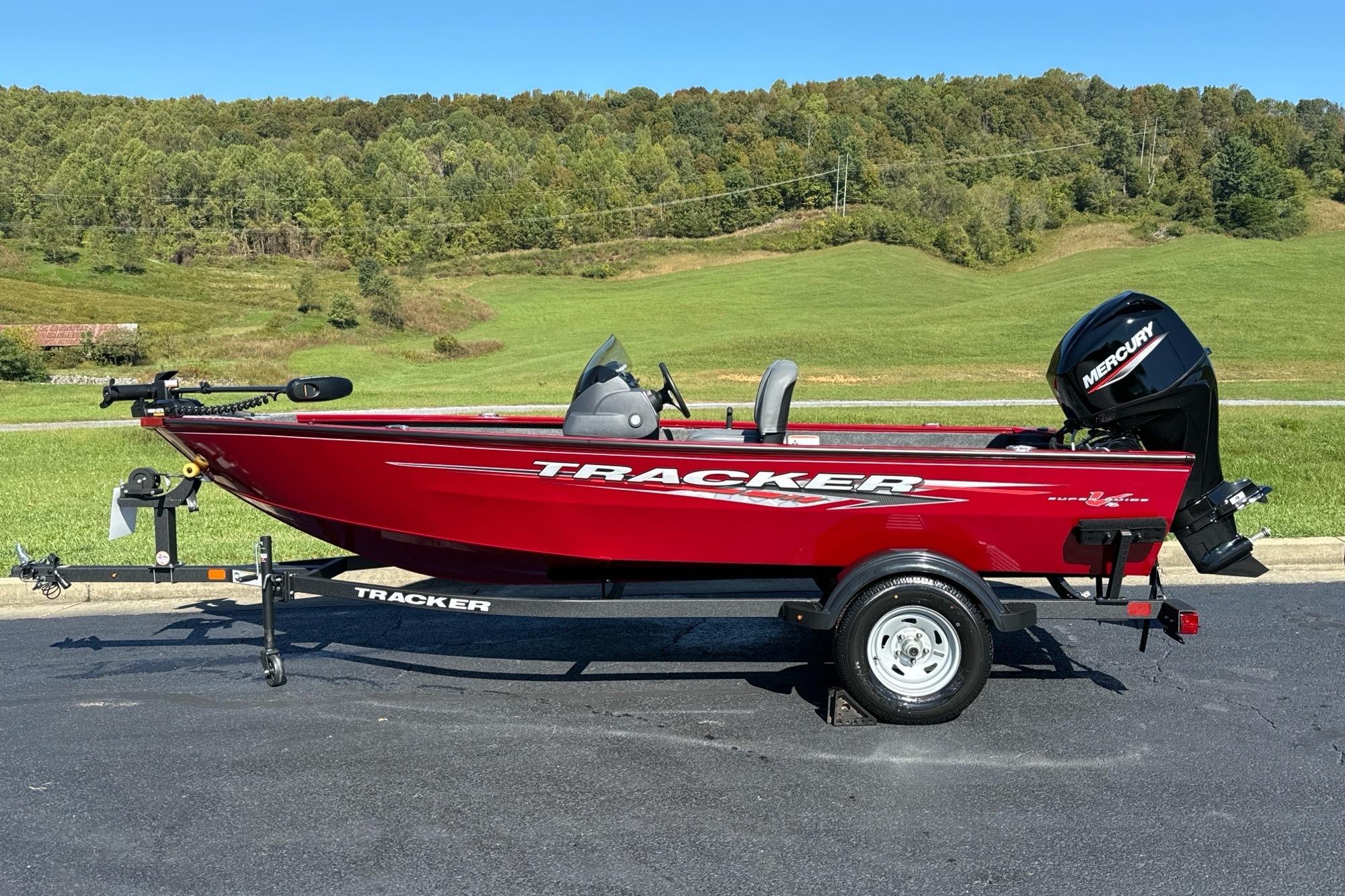 Tracker Super Guide V-16 SC 2026 Tracker Super Guide V-16 SC boat, red, on trailer, with Mercury outboard motor.