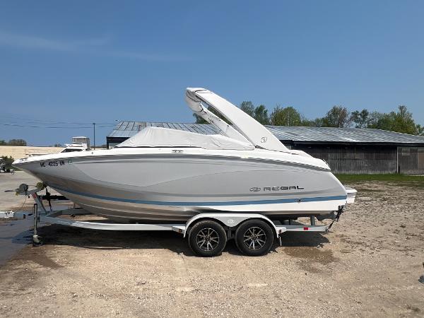 Regal 22 FasDeck 2021 Regal 22 FasDeck boat on a trailer, parked outdoors.