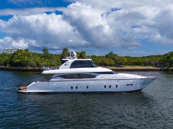 Maiora Custom Luxurious 2016 Maiora Custom yacht cruising on a serene waterway under a partly cloudy sky.