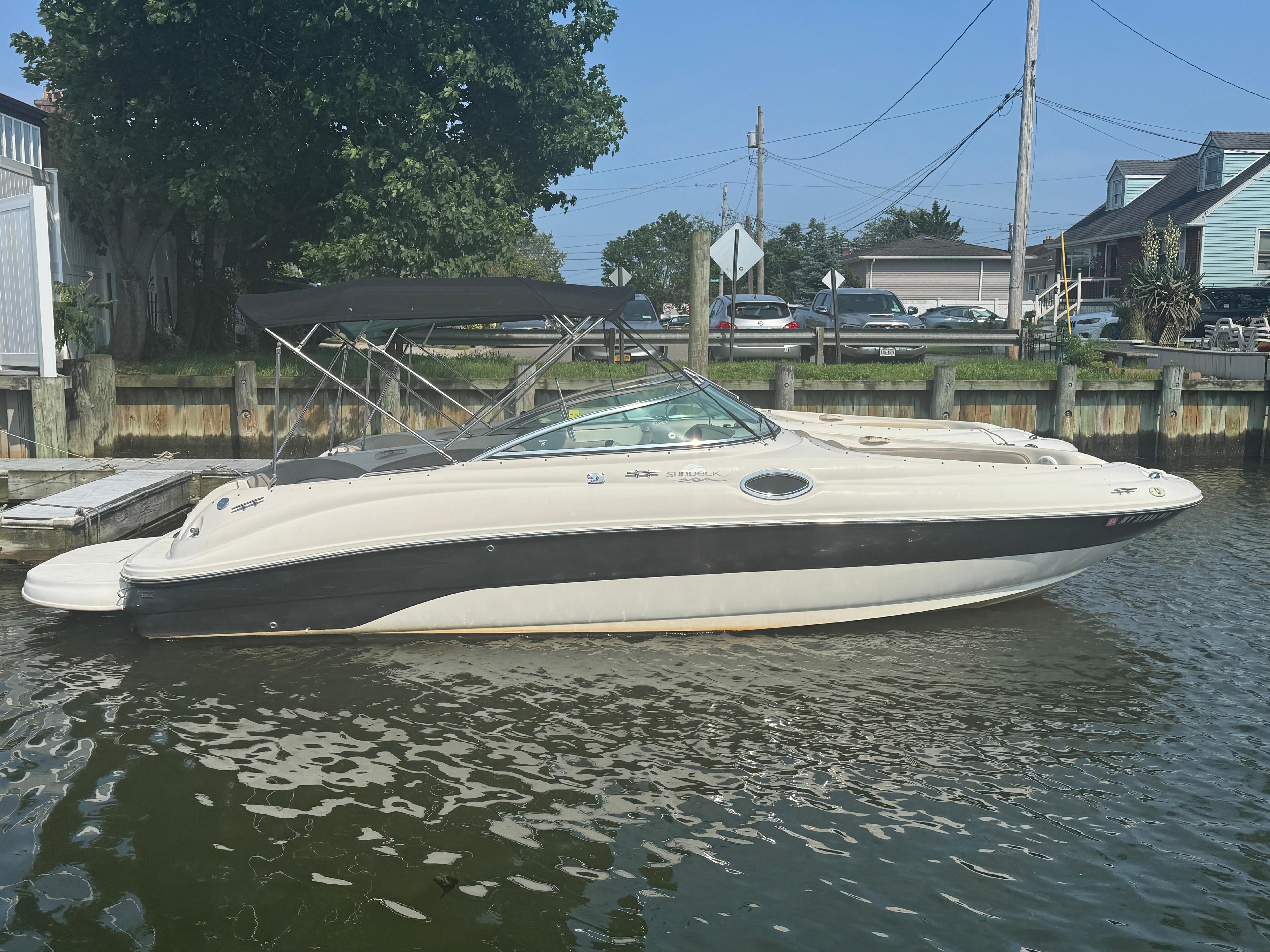 Sea Ray 240 Sundeck 2004 Sea Ray 240 Sundeck boat docked in a calm marina.