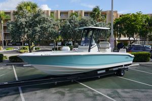 Boston Whaler 250 Dauntless 2026 Boston Whaler 250 Dauntless boat on trailer in parking lot, surrounded by trees.