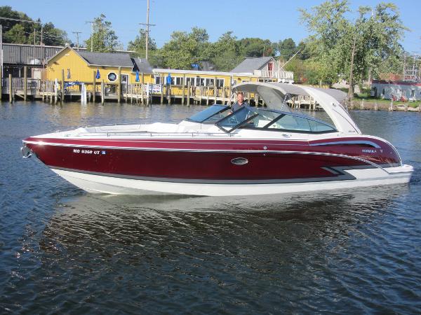 Formula 350 Crossover Bowrider 2019 Formula 350 Crossover Bowrider on water near dockside buildings.