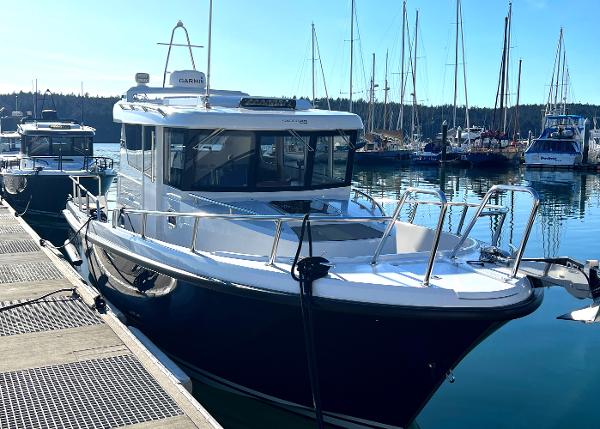 Sargo 28 2023 Sargo 28 boat docked in a marina with clear blue skies.